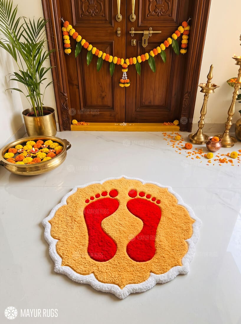 Diwali rangoli-inspired hand-tufted custom wool rug featuring red Lakshmi Charan-inspired footprints on a golden-yellow base with a scalloped ivory-white border by Mayur Rugs.