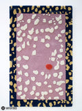 Blush Pebble abstract hand-tufted wool area rug featuring a dusty pink center, raised ivory pebble shapes, a navy blue border with mustard-gold motifs, and a terracotta-red accent by Mayur Rugs.