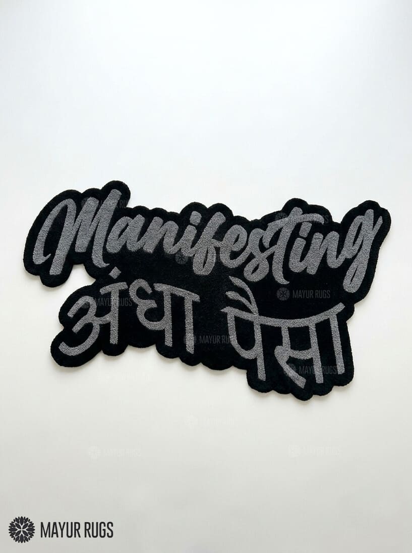Manifesting Andha Paisa hand-tufted custom wool rug featuring bold grey English and Hindi typography on a black background, designed for desi-inspired bedrooms, gaming rooms, and modern workspaces by Mayur Rugs.