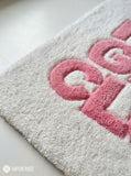 Square hand-tufted rug with bold pink “HOT GIRL CLUB” lettering and a star accent on an ivory-white background by Mayur Rugs.