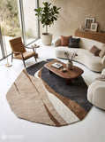 Modern abstract rug with an irregular organic shape, charcoal grey sections, taupe and brown curves, ivory bands, and fine linear detailing by Mayur Rugs.