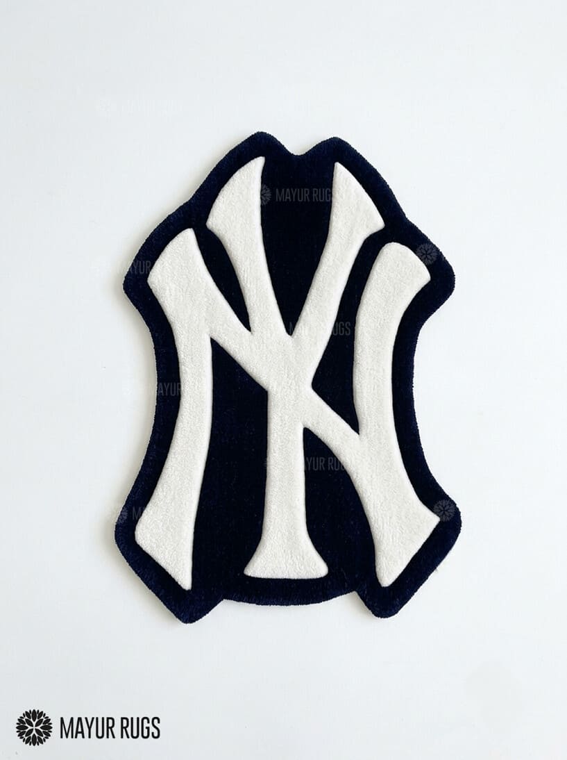 New York Yankees inspired hand-tufted custom wool rug featuring a cream interlocking NY baseball logo on a black background by Mayur Rugs.