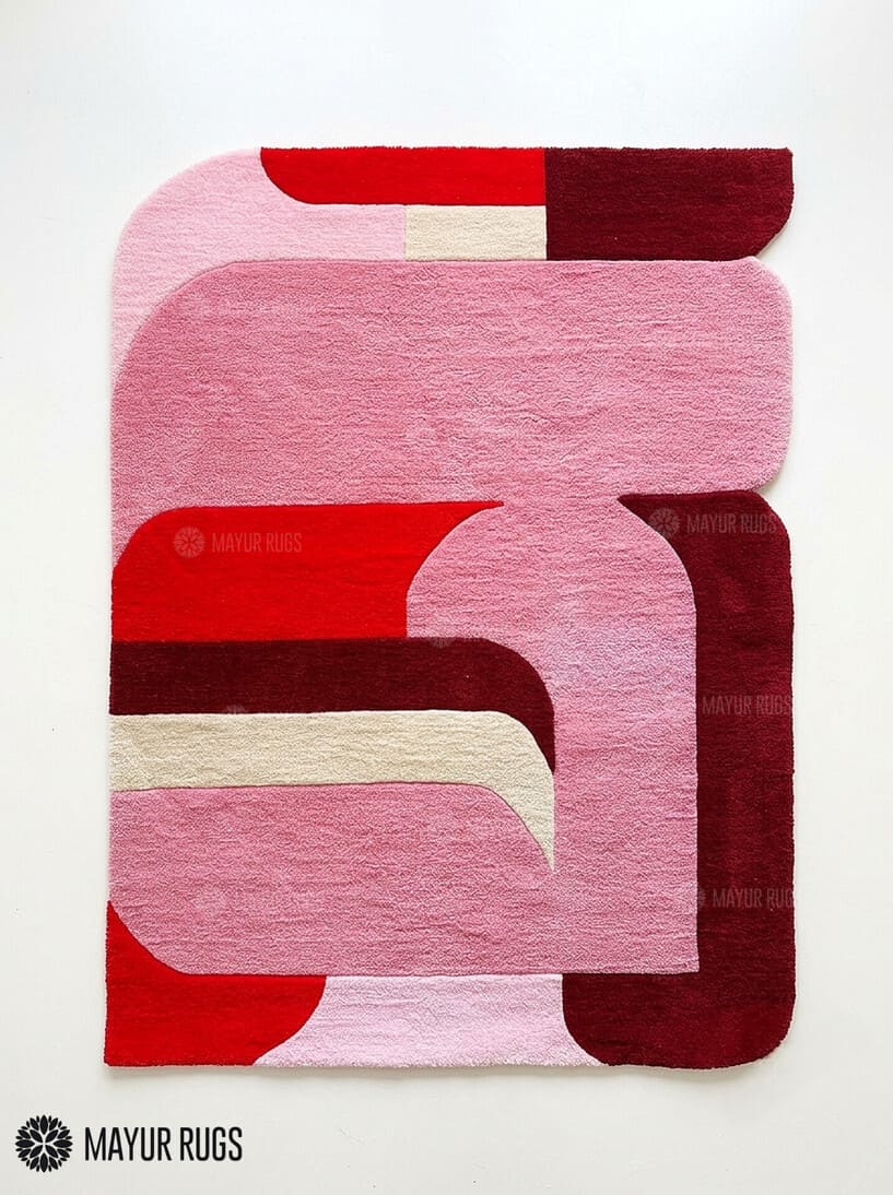 Pink Mirage abstract area rug featuring pink, red, burgundy, and ivory curved geometric shapes in a contemporary color-blocked design by Mayur Rugs.