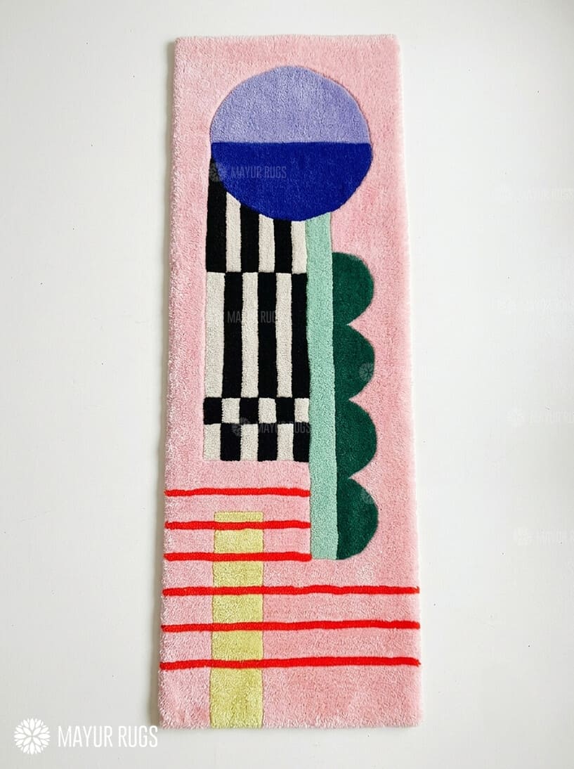Pink abstract hand-tufted runner rug featuring a blue and lavender circle, black-and-ivory stripes, green shapes, red lines, and yellow accents by Mayur Rugs.