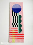 Pink abstract hand-tufted runner rug featuring a blue and lavender circle, black-and-ivory stripes, green shapes, red lines, and yellow accents by Mayur Rugs.