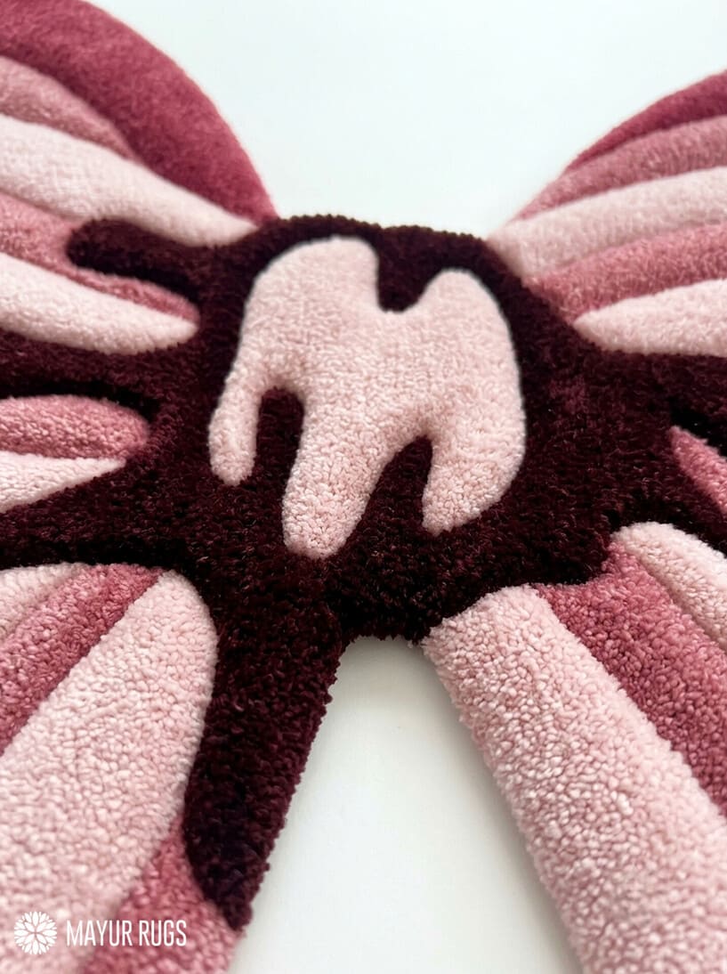 Pink ribbon bow 3D hand-tufted custom wool rug featuring layered blush, rose, dusty pink, and burgundy ribbon shapes with a sculpted center knot for coquette and feminine décor by Mayur Rugs.