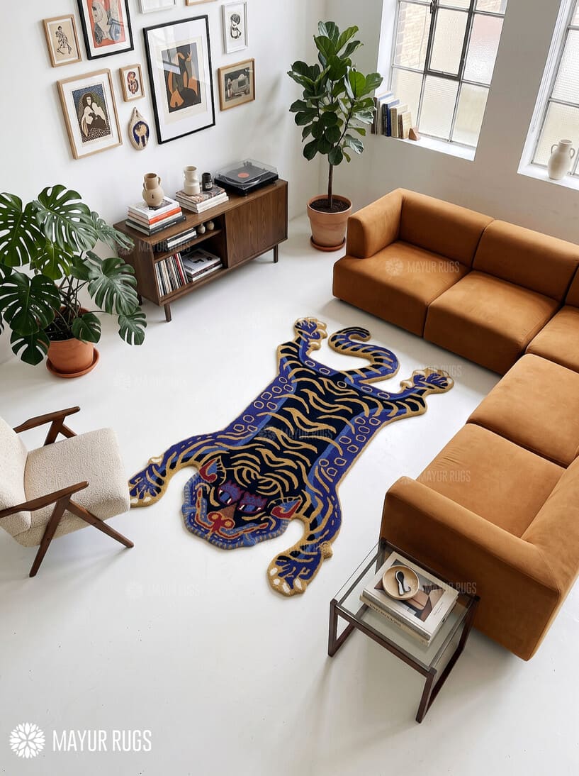 Tibetan tiger-inspired hand-tufted custom rug in blue, black, and golden beige featuring a full-body tiger design, curved tail, extended paws, and detailed tiger face by Mayur Rugs.